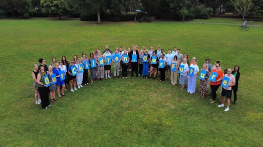 Photo by North East Lincolnshire|Photo by gstockstudio/AdobeStock|North East Lincolnshire DCS Ann-Marie Matson |Social worker talking to teenage girl while they sitting on sofa in the living room with foster parents
